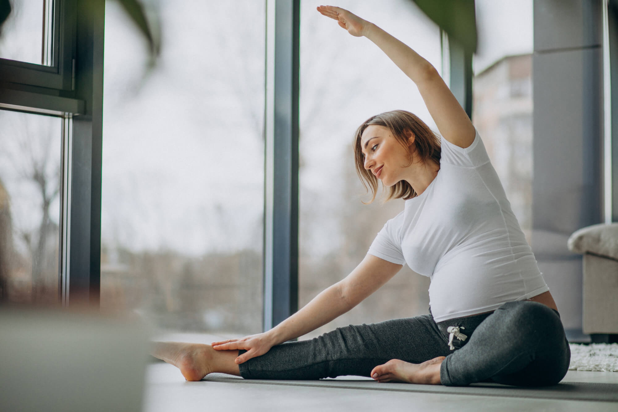 e1mzc_2000_youngpregnantwomanpracticingyogahome